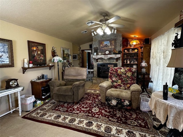 16296 N County Road 3264th Rd, Pauls Valley, OK 73075 - carpeted living area featuring vaulted ceiling, a wood stove, a ceiling fan, and visible vents