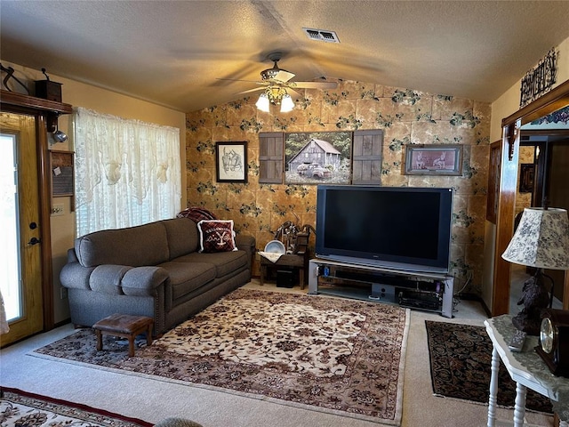 16296 N County Road 3264th Rd, Pauls Valley, OK 73075 - carpeted living area featuring a textured ceiling, ceiling fan, vaulted ceiling, and visible vents