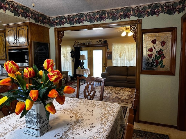 16296 N County Road 3264th Rd, Pauls Valley, OK 73075 - carpeted dining area featuring baseboards, a textured ceiling, and ceiling fan