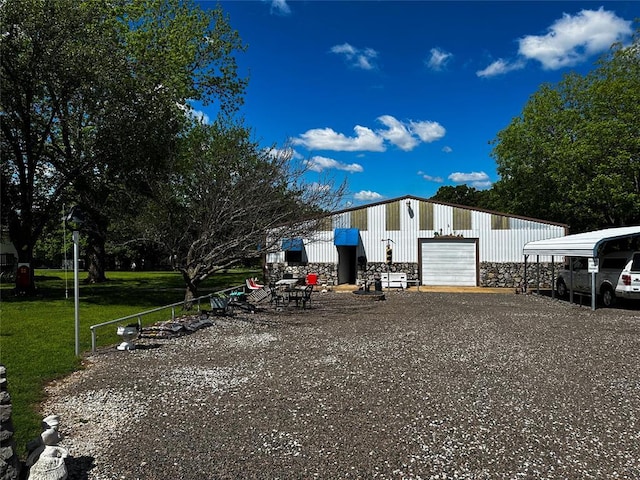 16296 N County Road 3264th Rd, Pauls Valley, OK 73075 - exterior space with a lawn, an outbuilding, stone siding, and a garage