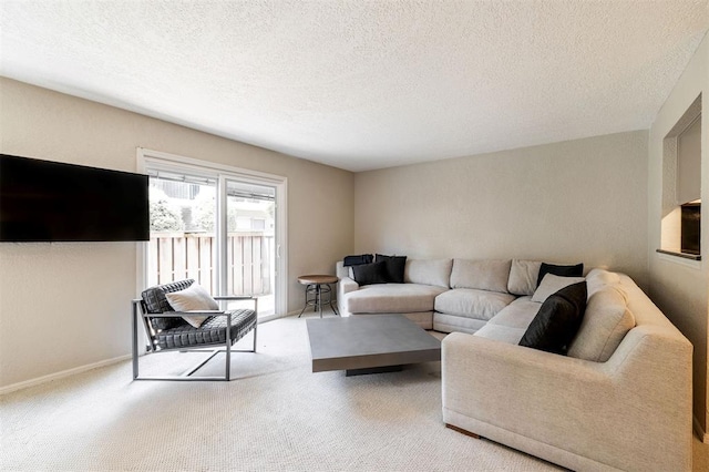 living area with carpet floors and a textured ceiling