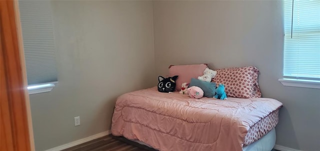 bedroom featuring dark wood-style flooring and baseboards