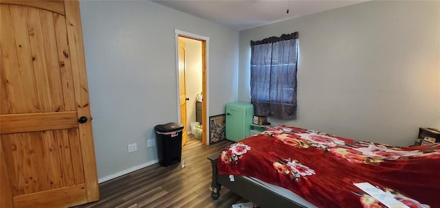 bedroom with baseboards and wood finished floors