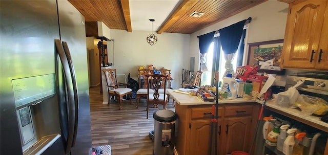 kitchen featuring a peninsula, wood finished floors, stainless steel fridge, light countertops, and wood ceiling