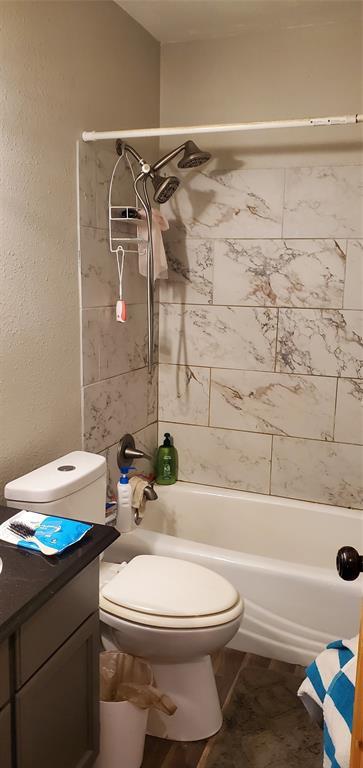 234 S 5th Ave, Stroud, OK 74079 - bathroom with toilet, bathing tub / shower combination, and vanity