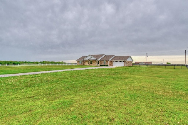 34701 E County Road 1610, Pauls Valley, OK 73075 - view of front facade with concrete driveway, fence, a front yard, and an attached garage