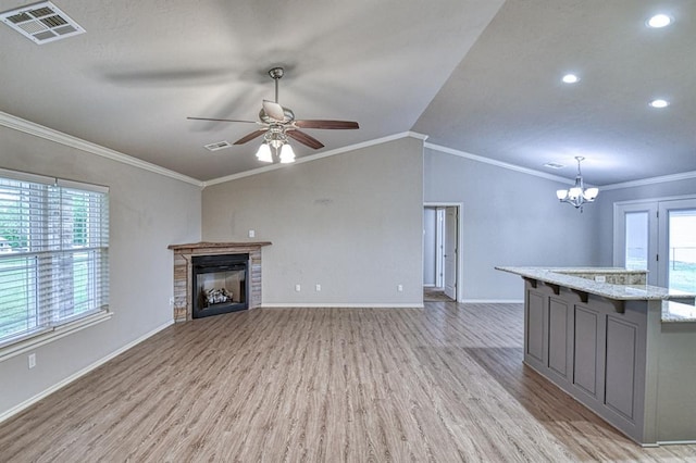 34701 E County Road 1610, Pauls Valley, OK 73075 - unfurnished living room featuring light wood-style floors, a glass covered fireplace, visible vents, and ceiling fan with notable chandelier