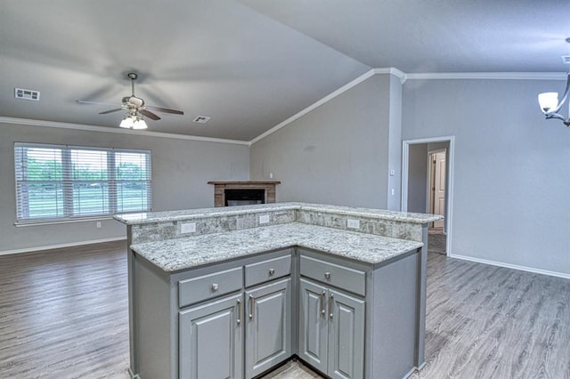 34701 E County Road 1610, Pauls Valley, OK 73075 - kitchen with visible vents, ceiling fan, light wood-style flooring, a center island, and gray cabinetry