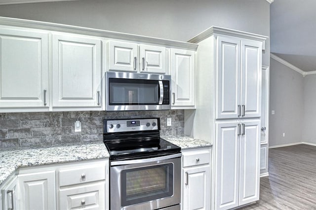 34701 E County Road 1610, Pauls Valley, OK 73075 - kitchen featuring crown molding, white cabinetry, baseboards, backsplash, and appliances with stainless steel finishes