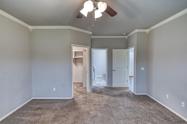 34701 E County Road 1610, Pauls Valley, OK 73075 - unfurnished bedroom featuring baseboards, ornamental molding, carpet, and a walk in closet