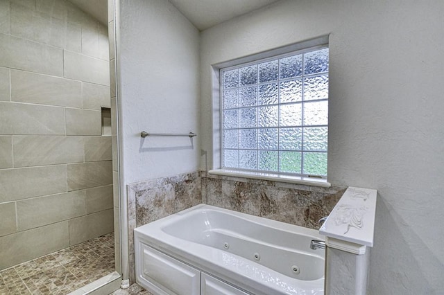 34701 E County Road 1610, Pauls Valley, OK 73075 - full bath with a whirlpool tub, tiled shower, and a textured wall