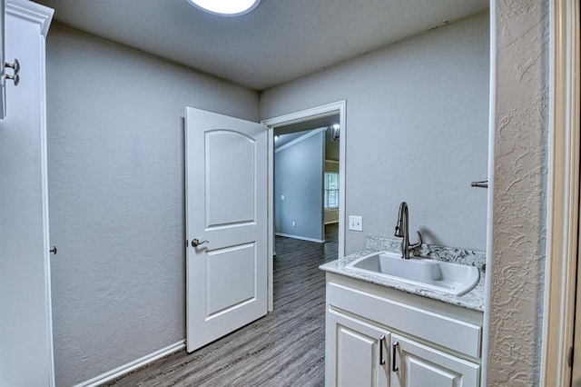 34701 E County Road 1610, Pauls Valley, OK 73075 - interior space featuring baseboards, vanity, a textured wall, and wood finished floors