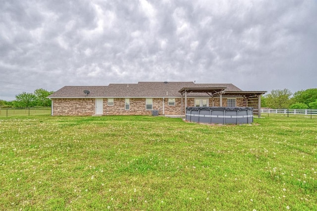 34701 E County Road 1610, Pauls Valley, OK 73075 - rear view of house featuring a yard, a pergola, a covered pool, and fence