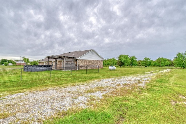 34701 E County Road 1610, Pauls Valley, OK 73075 - view of side of property with a yard, fence, and stone siding