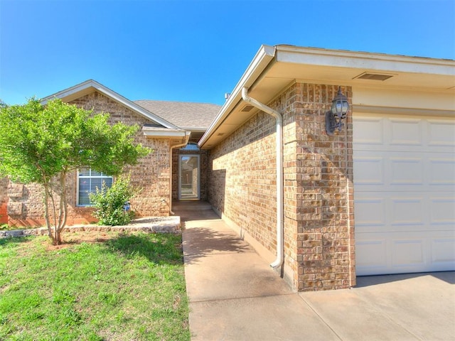 8233 Greer Way, Oklahoma City, OK 73132 - view of exterior entry with brick siding and a garage