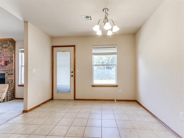 8233 Greer Way, Oklahoma City, OK 73132 - doorway with a chandelier, a fireplace, baseboards, and light tile patterned flooring