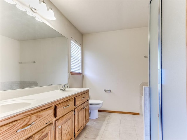 8233 Greer Way, Oklahoma City, OK 73132 - bathroom featuring toilet, baseboards, double vanity, and tile patterned floors