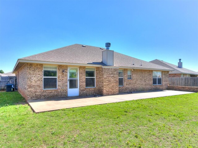 8233 Greer Way, Oklahoma City, OK 73132 - rear view of property featuring a patio, brick siding, a shingled roof, and a chimney