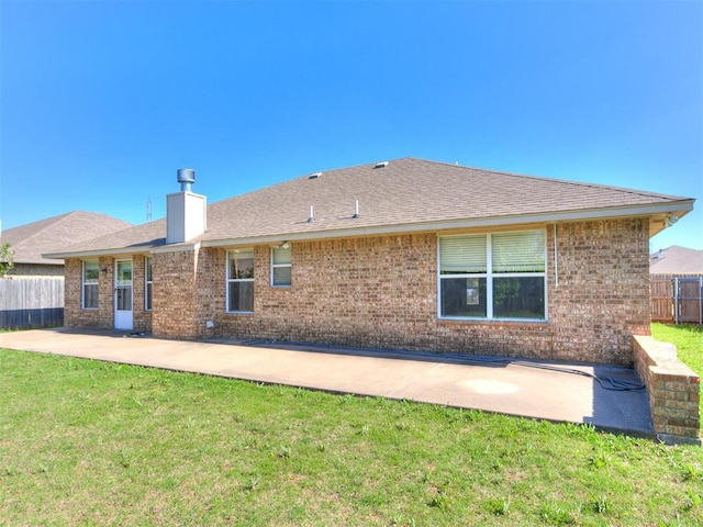8233 Greer Way, Oklahoma City, OK 73132 - back of property featuring a patio, a chimney, brick siding, and roof with shingles
