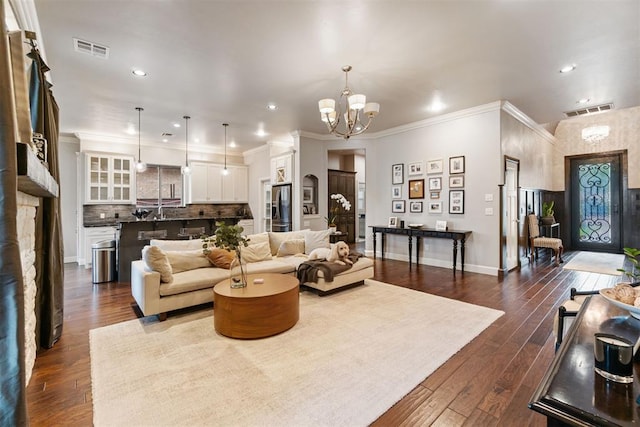 living area featuring recessed lighting, a notable chandelier, and visible vents