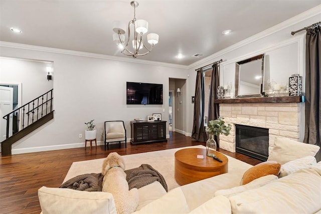 living room with hardwood / wood-style flooring, ornamental molding, visible vents, stairway, and baseboards