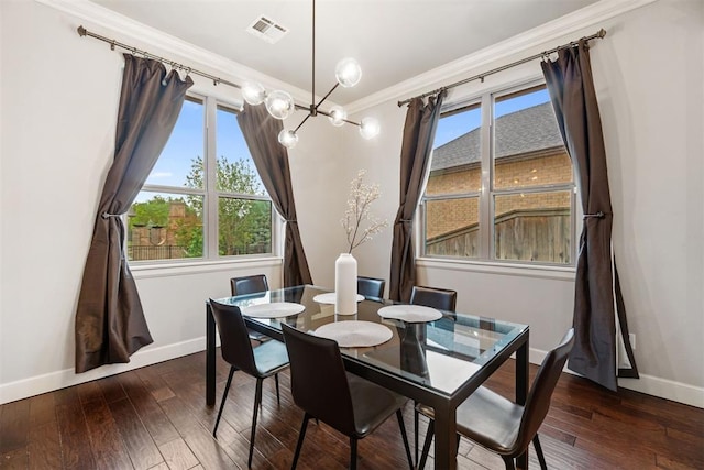 dining room featuring ornamental molding, a notable chandelier, baseboards, and visible vents