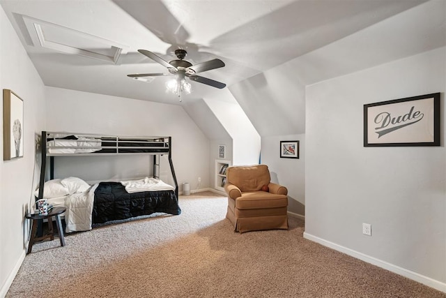 carpeted bedroom with baseboards, ceiling fan, attic access, and vaulted ceiling