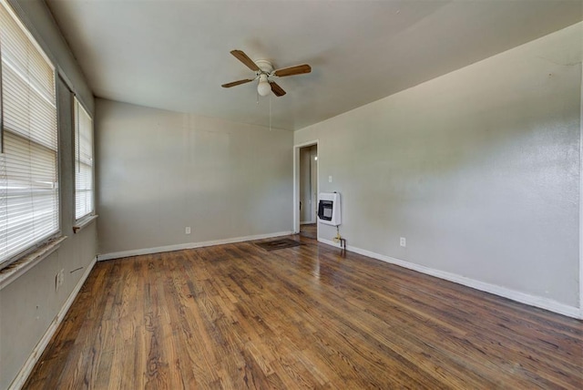 3924 Teal Dr, Del City, OK 73115 - unfurnished room featuring heating unit, a ceiling fan, wood finished floors, and baseboards