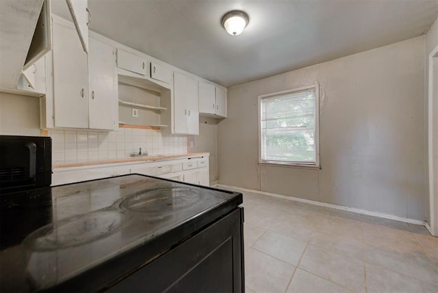 3924 Teal Dr, Del City, OK 73115 - kitchen with backsplash, light tile patterned flooring, white cabinets, baseboards, and electric stove