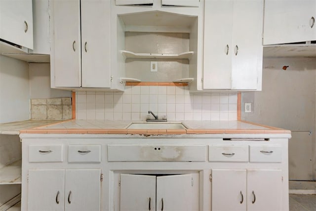 3924 Teal Dr, Del City, OK 73115 - kitchen featuring white cabinets, a sink, tasteful backsplash, tile countertops, and open shelves