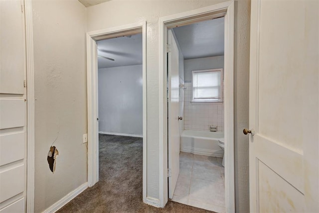 3924 Teal Dr, Del City, OK 73115 - hall with dark carpet, baseboards, and dark tile patterned floors