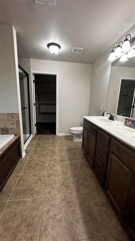 1328 Ridgeway Dr, Moore, OK 73160 - bathroom featuring vanity, a bath, a stall shower, and tile patterned flooring
