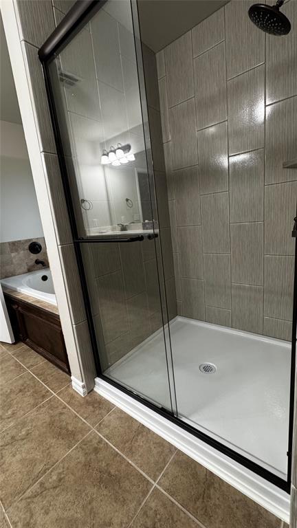 1328 Ridgeway Dr, Moore, OK 73160 - bathroom featuring a stall shower, a bath, and tile patterned flooring