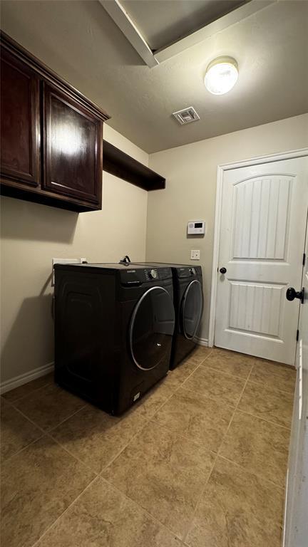1328 Ridgeway Dr, Moore, OK 73160 - laundry room with cabinet space, independent washer and dryer, and light tile patterned floors