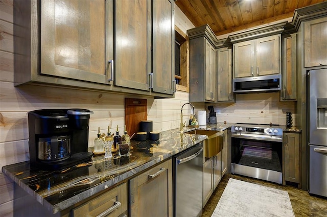 kitchen featuring wooden ceiling, appliances with stainless steel finishes, tasteful backsplash, a sink, and dark stone counters