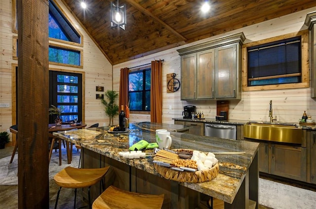 kitchen with wood walls, a sink, stainless steel dishwasher, dark stone countertops, and high vaulted ceiling