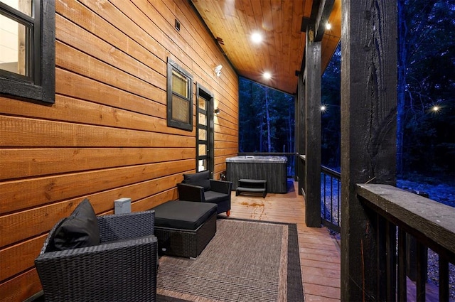 exterior space featuring a hot tub and a wooden deck