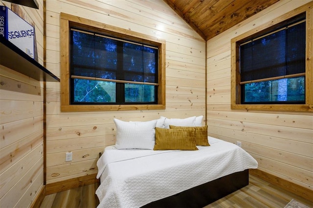 bedroom with wooden walls, wooden ceiling, vaulted ceiling, and wood finished floors