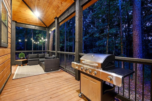 wooden terrace featuring an outdoor living space and area for grilling