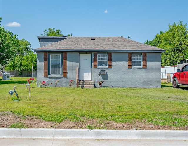 2717 SW 42nd St, Oklahoma City, OK 73119 - view of front facade with a front yard, a shingled roof, brick siding, and entry steps