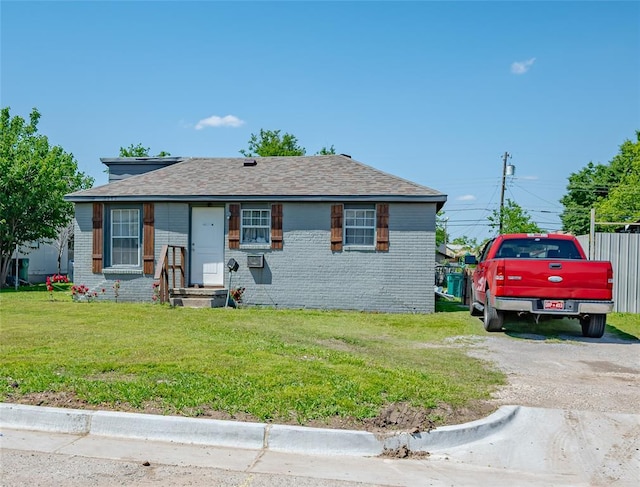 2717 SW 42nd St, Oklahoma City, OK 73119 - view of front of home with a shingled roof, brick siding, fence, and a front yard