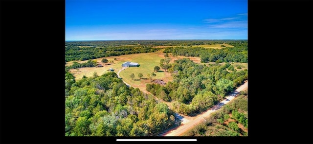 drone / aerial view featuring a forest view