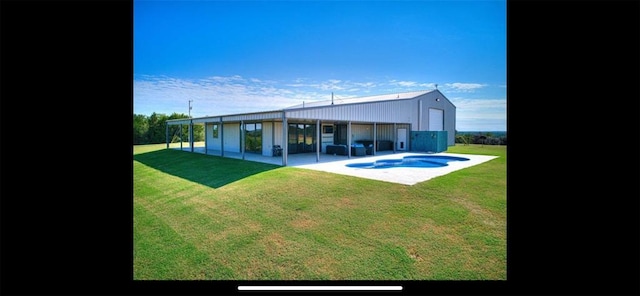 back of property with a yard, a patio, and a jacuzzi