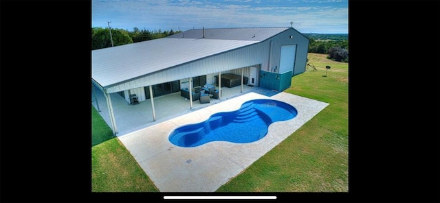 pool with a yard and a patio area