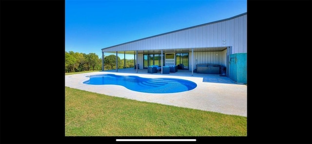 pool featuring a patio and an outdoor living space