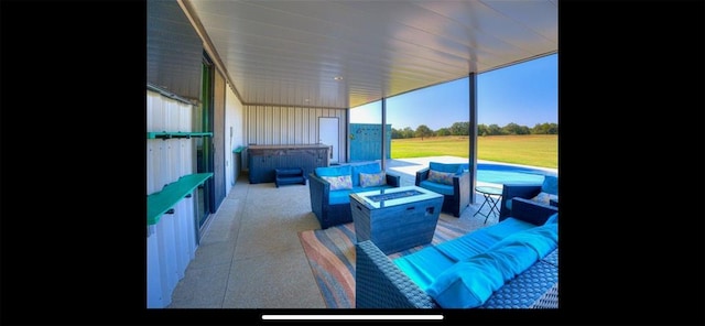 view of patio with an outdoor living space with a fire pit and a hot tub
