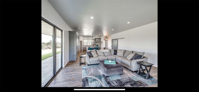 living room with light wood-style flooring and recessed lighting