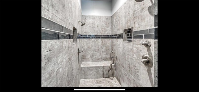 full bathroom with a tile shower
