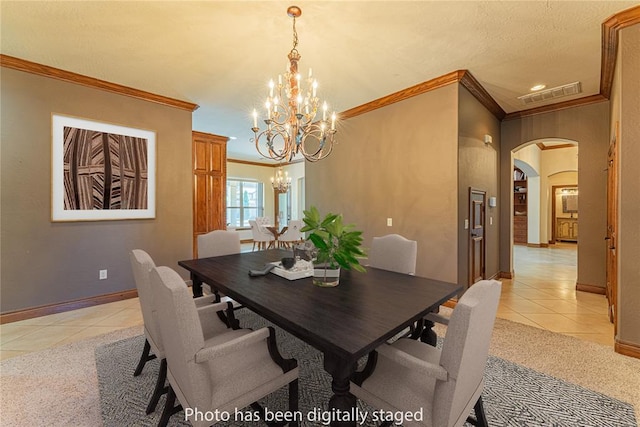 2612 SW 137th St, Oklahoma City, OK 73170 - dining space with light tile patterned floors, a chandelier, arched walkways, ornamental molding, and baseboards