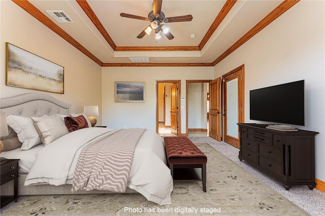 2612 SW 137th St, Oklahoma City, OK 73170 - bedroom with a tray ceiling, crown molding, baseboards, carpet, and ceiling fan